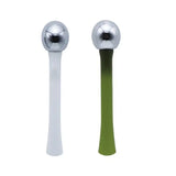 a pair of spoons with a green handle