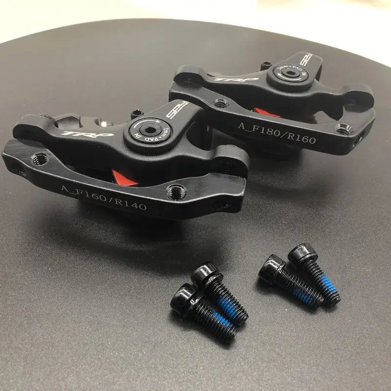 two black brake pads on a black table