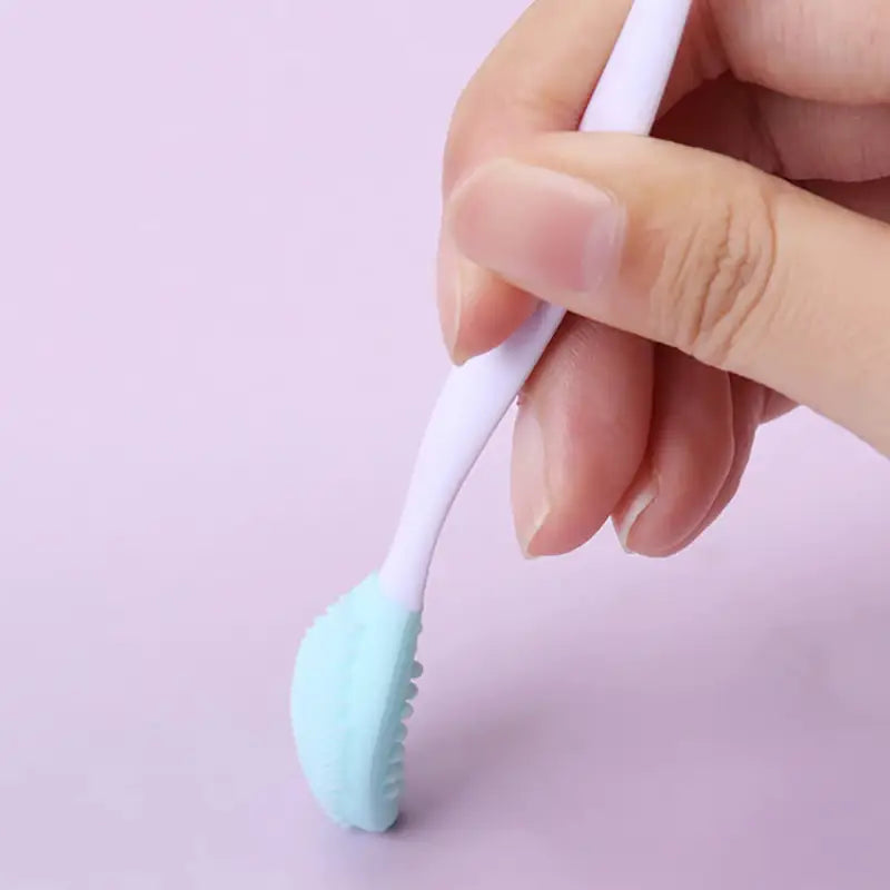 a person holding a toothbrush in their hand