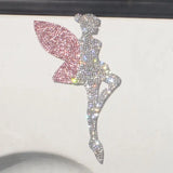 there is a picture of a fairy sitting on a car