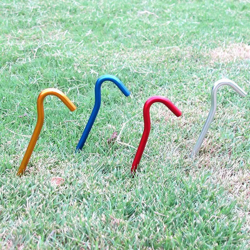 three colorful plastic stirs on grass