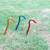 three colorful plastic stirs on grass