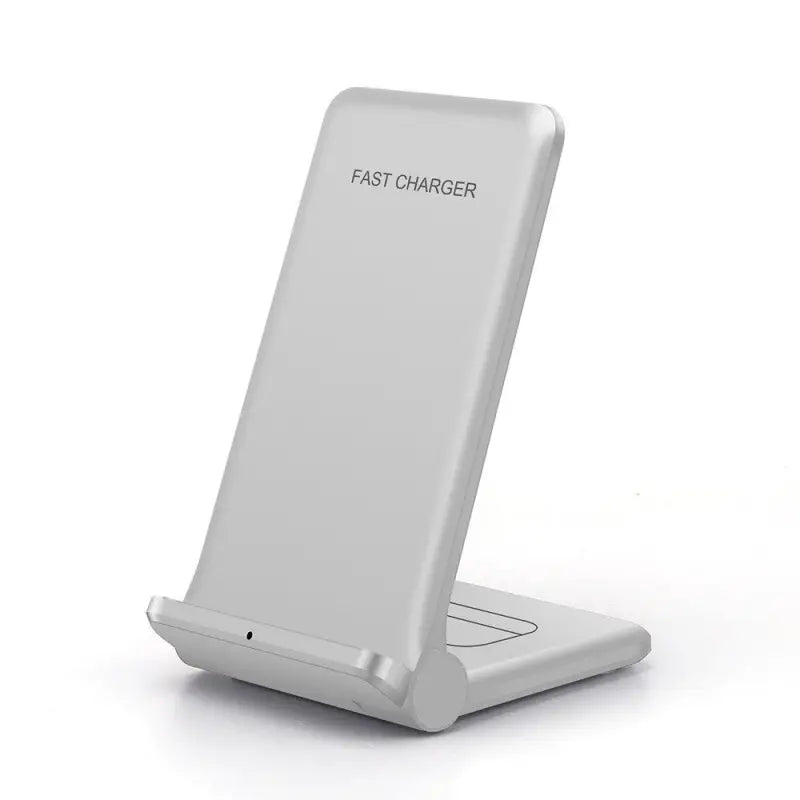 a close up of a white cell phone charging station on a white surface