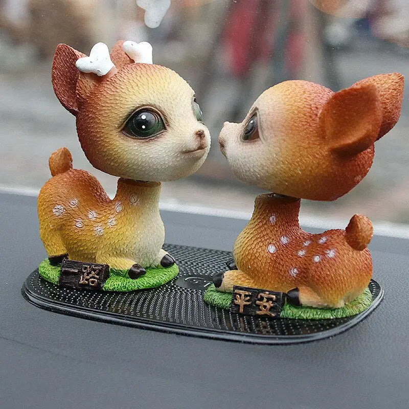 a couple of deers kissing on a table