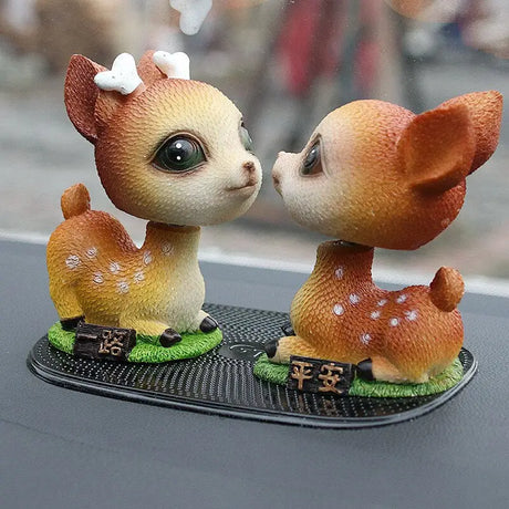 a couple of deers kissing on a table