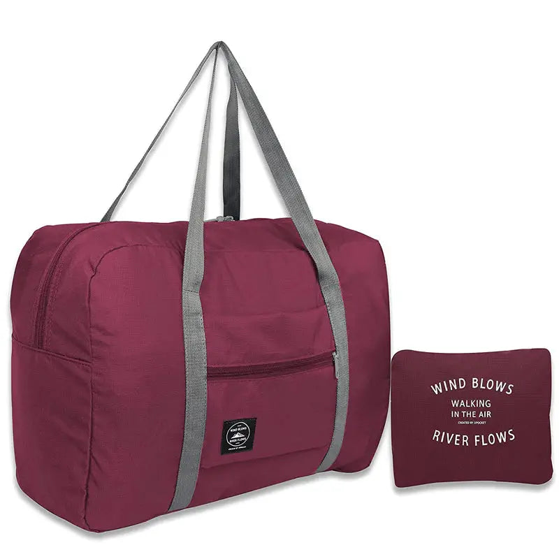 a maroon duff bag with a grey zipper