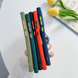 Five colorful silicone phone cases with contrasting buttons