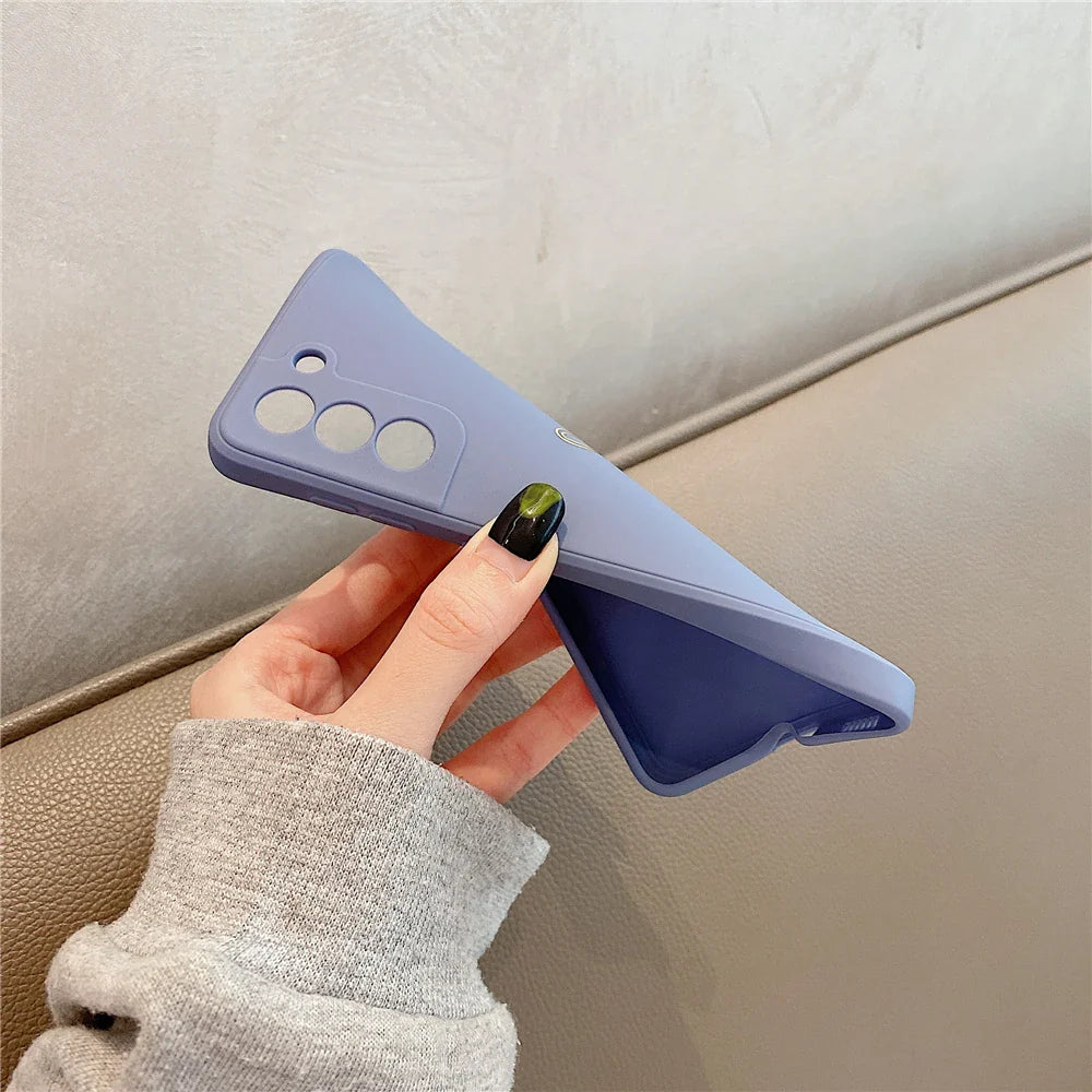 Flexible lavender phone case with dark green manicured fingernail holding it.