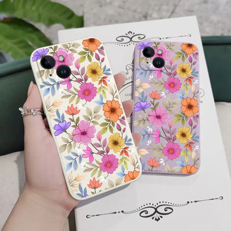 a woman holding a phone case with flowers on it