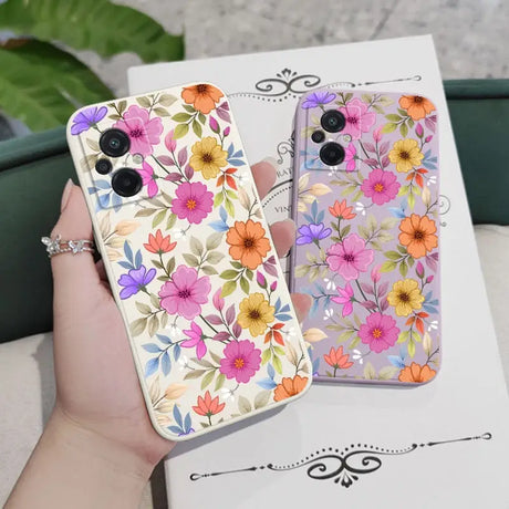 a woman holding a phone case with flowers on it