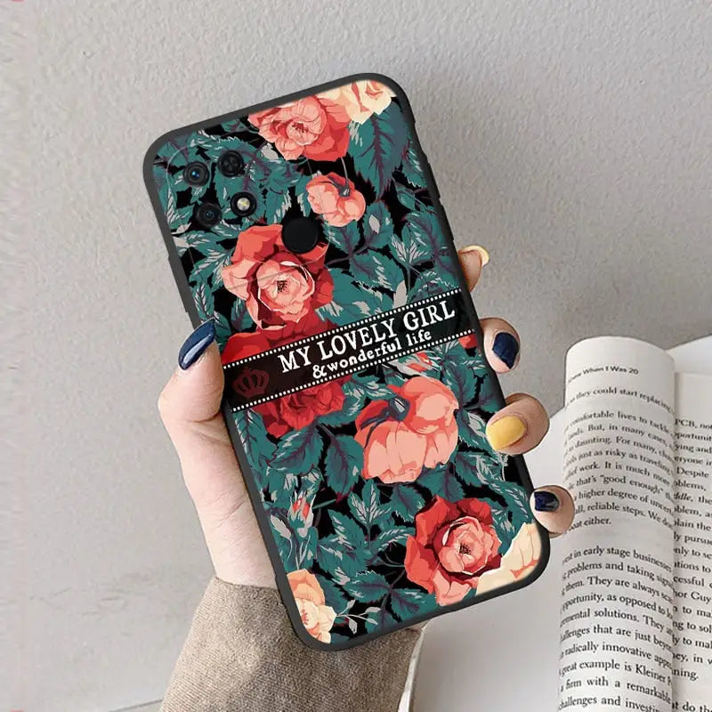 a woman holding a phone case with flowers on it