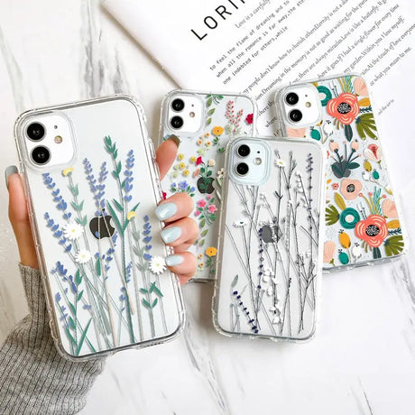 a woman holding a phone case with flowers and plants