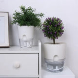 a white dresser with two pots and a plant