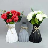 three vases with flowers in them
