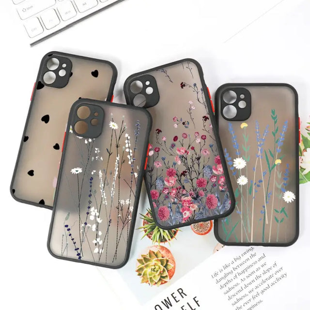 three iphone cases with flowers and leaves on them
