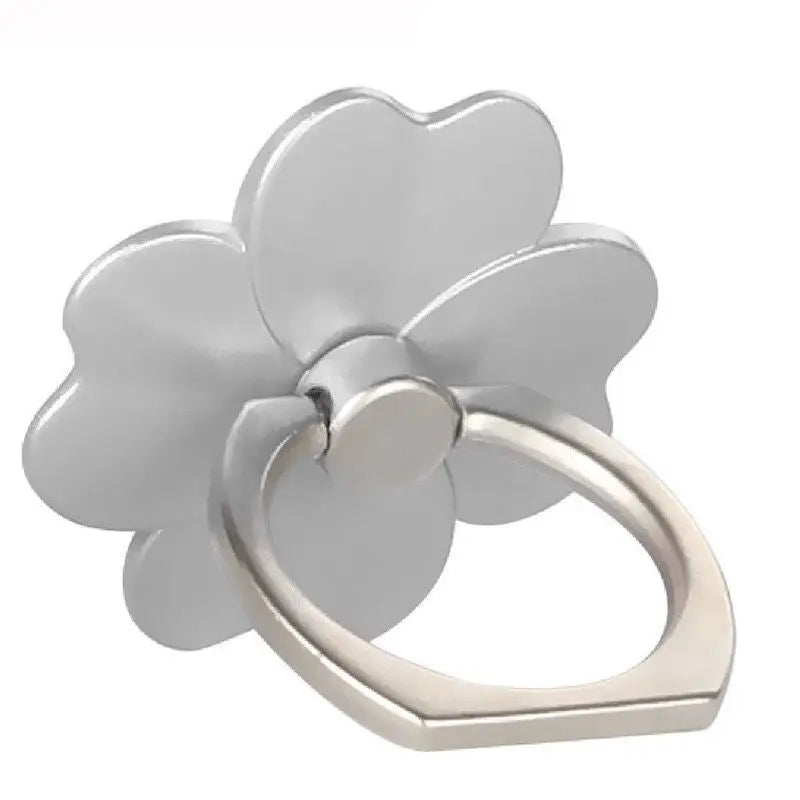 a flower shaped ring with a silver finish