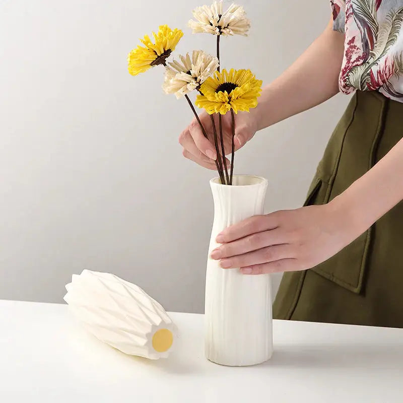 a woman is putting flowers in a vase