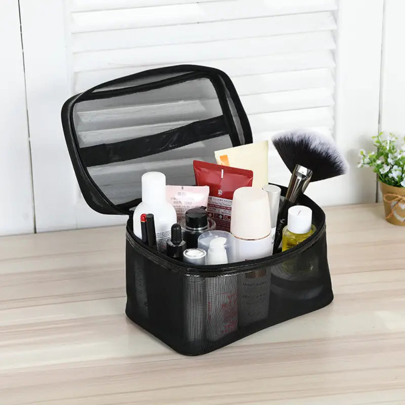 a black makeup case with makeup brushes and cosmetics products