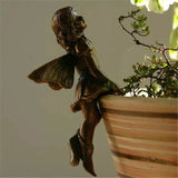a statue of a butterfly sitting on top of a pot