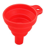a red plastic funnel funnel with a hole in the middle