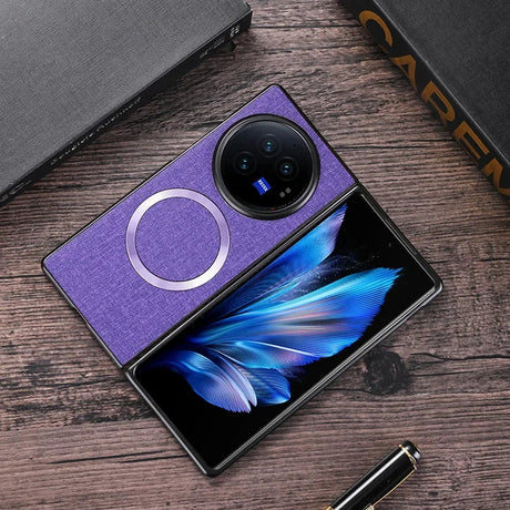 Foldable smartphone with a purple cover and a circular camera module, displaying a vibrant blue feather image on its screen.