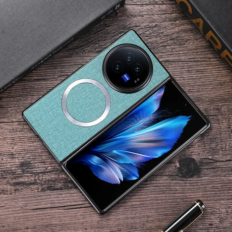 Foldable smartphone with a teal cover and prominent circular camera module, displaying a vibrant blue feather on its inner screen.