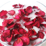 a bowl filled with rose petals and water