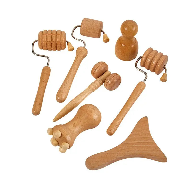 a close up of a bunch of wooden tools on a white surface