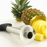 there is a pineapple and a knife on a table