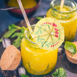 two glasses of mango margarita with straw straws and a straw straw