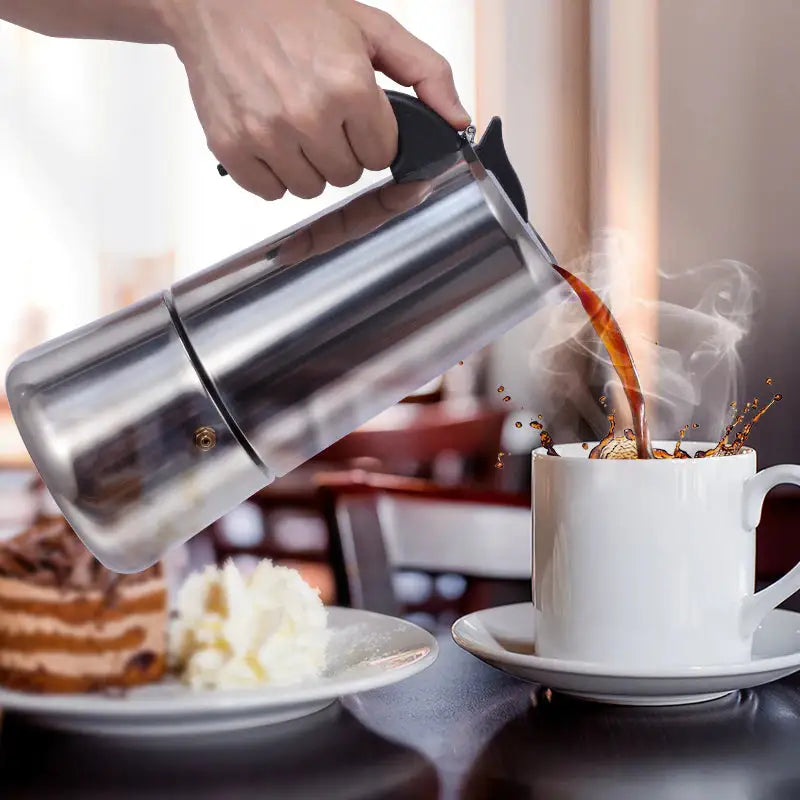 a person pouring coffee into a cup