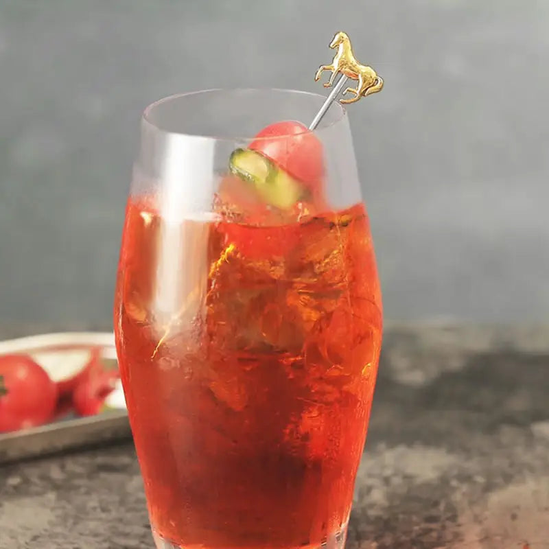 a glass filled with a red drink and garny garny garny garny ga