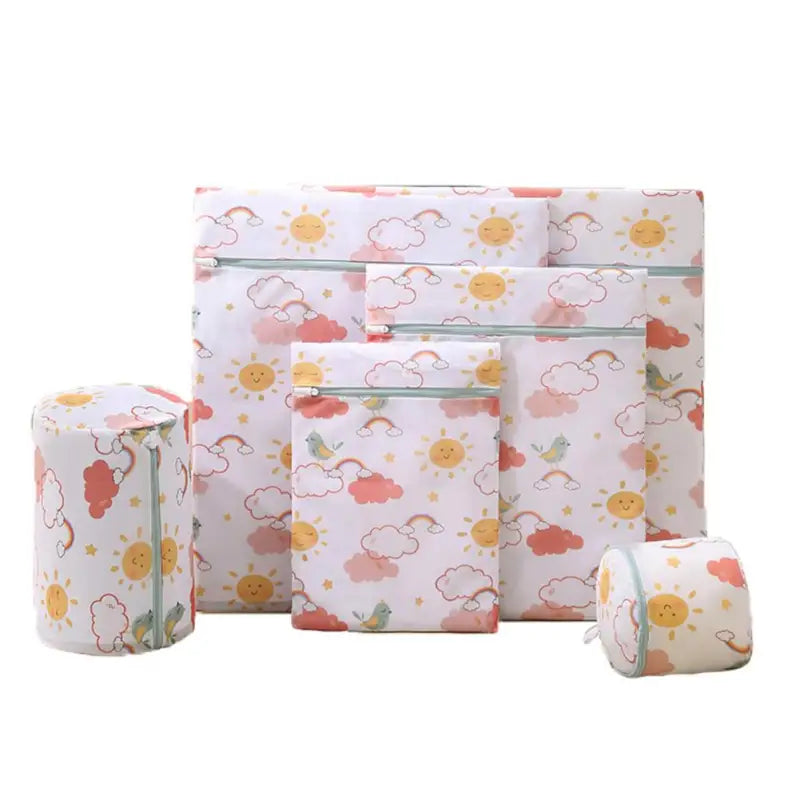 a set of four rolls of toilet paper with a pattern of clouds and sun