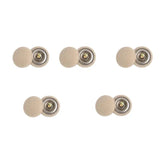 a set of four metal buttons with a gold button