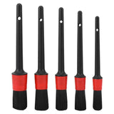 four black and red brushes with red handles