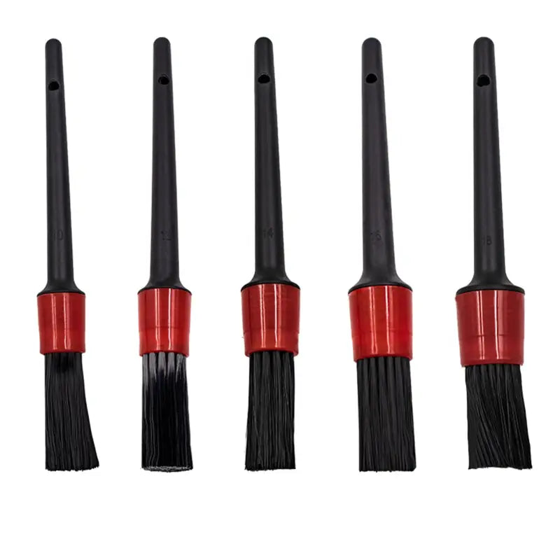four black and red brushes with red handles on a white background