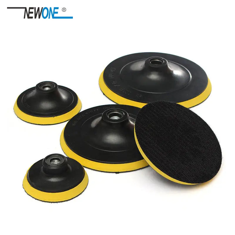 a set of four black and yellow polish pads with a yellow pad