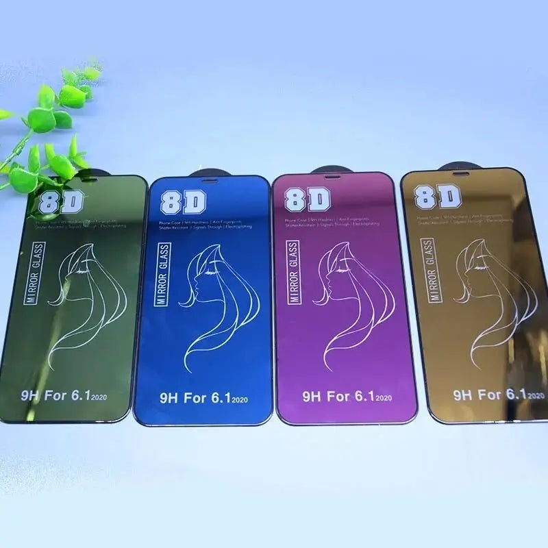 four different colored cell phones with a plant in the background