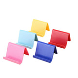 a set of four colorful plastic business card holders