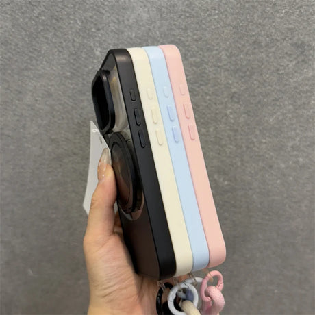 Four colorful phone cases stacked together, with a hand holding the outermost black case that features a pop socket.