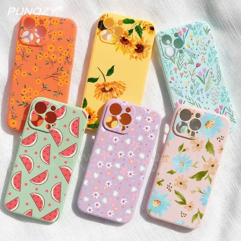 four colorful phone cases with flowers and fruit