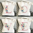 four different images of a tote bag with the letter g painted on it