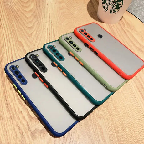 several different colors of cases are lined up on a table