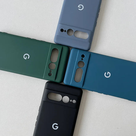 Four smartphone cases in different colors (gray, green, blue, and black) arranged in a cross pattern, each featuring a Google ’G’ logo.