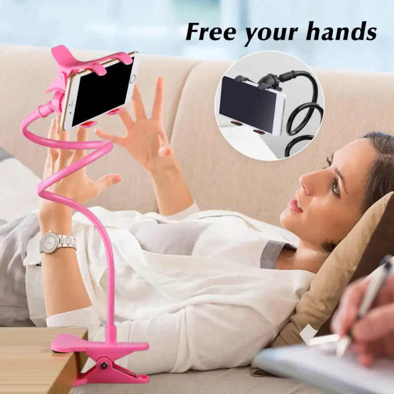 a woman laying on a couch with a pink phone holder