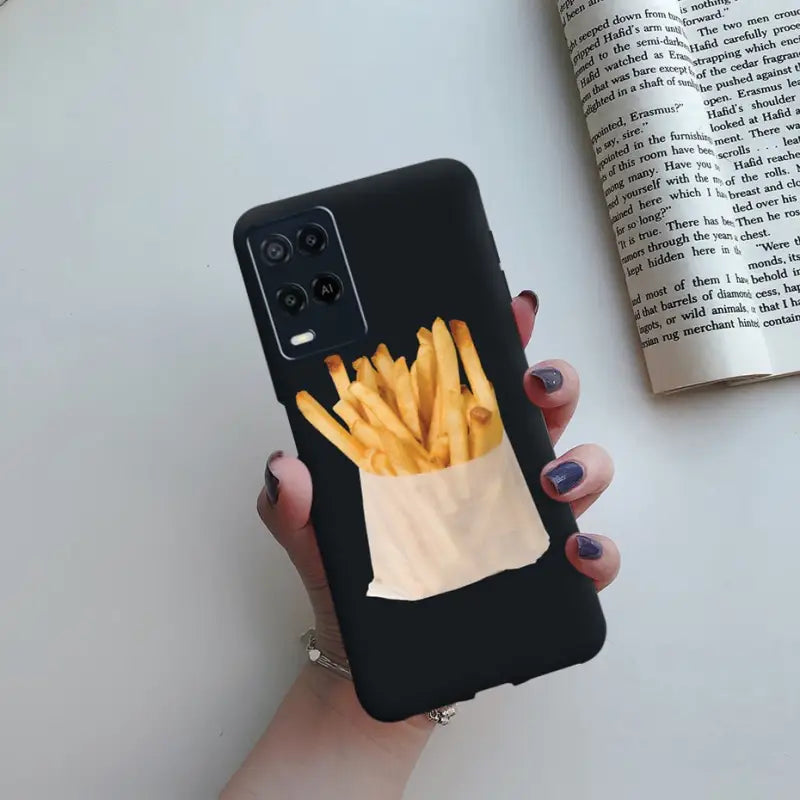 a woman holding a phone case with fries in it