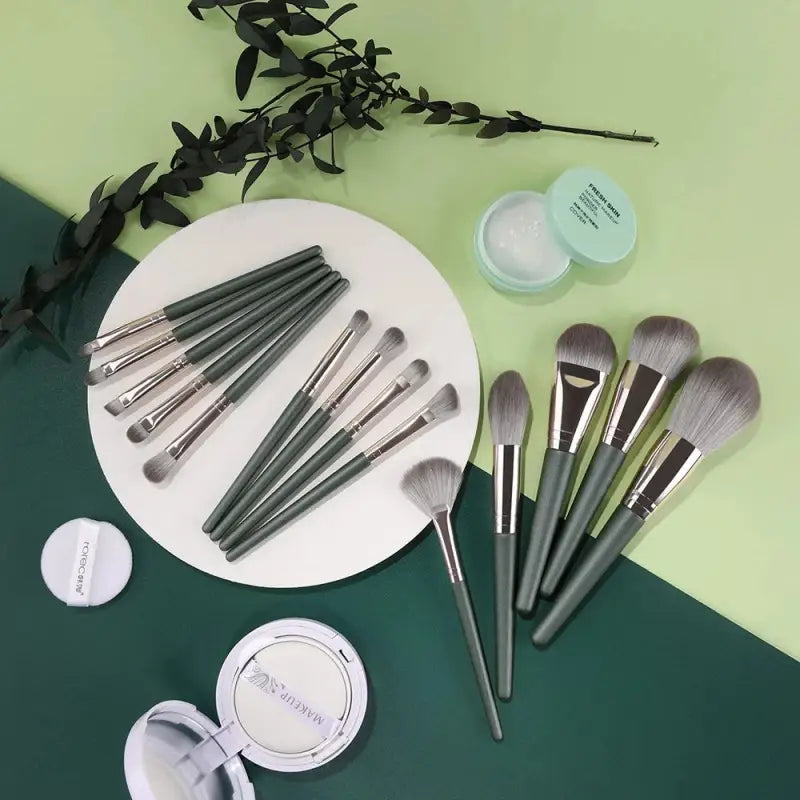 the makeup brush set is on a green table