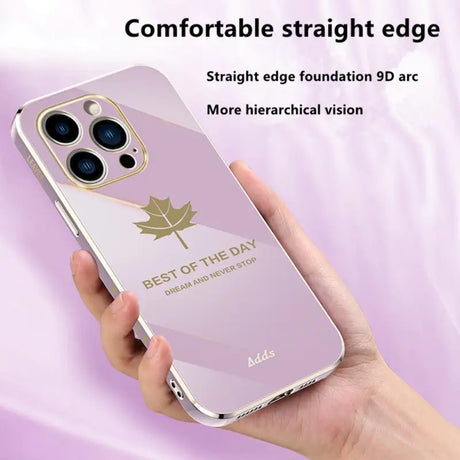 a hand holding a pink iphone case with a gold leaf on it