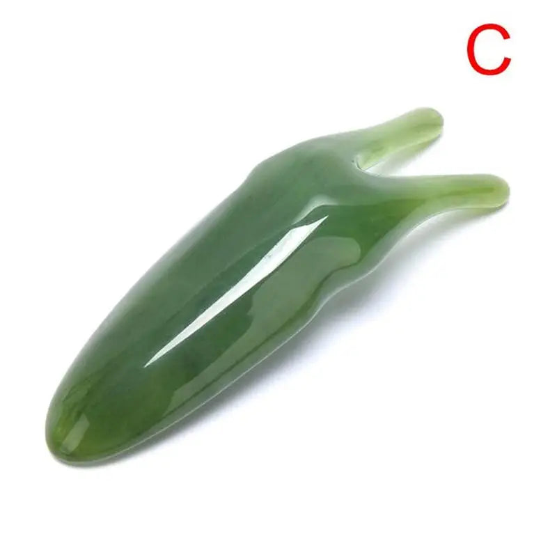 there is a green pepper shaped object on a white surface