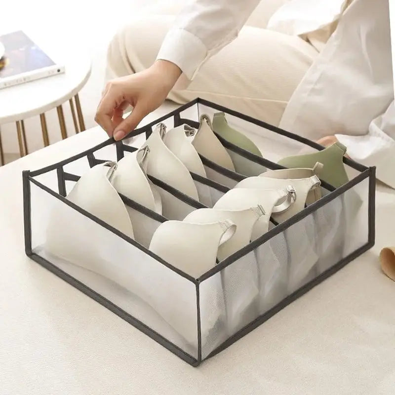 a woman is putting a pair of shoes in a box